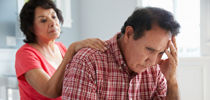 Wife Comforting Senior Husband Suffering With Dementia