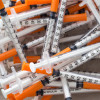 Close up of used syringes in the trash