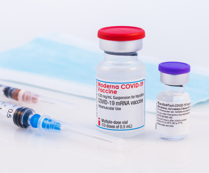 Pfizer BioNTech and Moderna Covid-19 vaccine on a white background.
