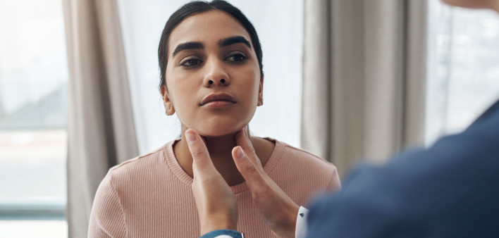 doctor checking patients throid gland
