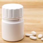 white pills and pill bottle medication generic image