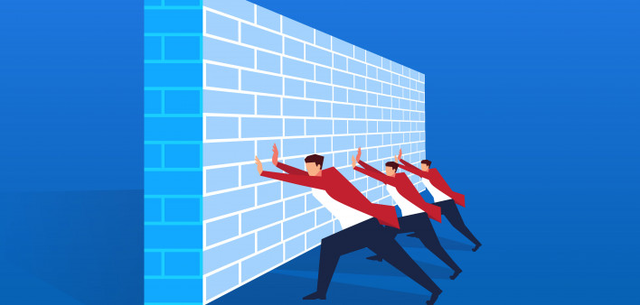 Businessman working hard together trying to push the wall