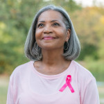Beautiful senior woman smiles while walking for breast cancer awareness