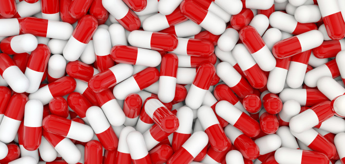 A pile of red and white capsules